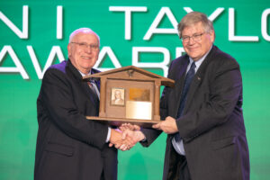 Okmulgee County Farm Bureau President Jim Meek (left) accepts the 2023 Oklahoma Farm Bureau John I. Taylor Award from Oklahoma Farm Bureau President Rodd Moesel on Saturday, Nov. 11 at the 2023 Oklahoma Farm Bureau Annual Meeting in Oklahoma City.