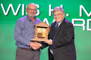 Garfield County Farm Bureau President Joe Peeper (left) accepts the 2023 Oklahoma Farm Bureau Lewis H. Munn Award from Oklahoma Farm Bureau President Rodd Moesel on Saturday, Nov. 11 at the 2023 Oklahoma Farm Bureau Annual Meeting in Oklahoma City.