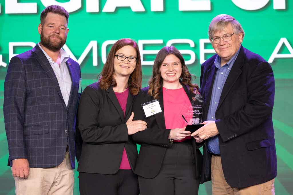 Oklahoma Farm Bureau Young Farmers & Ranchers chairs Jared and Alisen Anderson (left) and OKFB President Rodd Moesel (right) present Taylor Fent of Northeastern Oklahoma A&M College with the OKFB YF&R Moesel Award on Saturday, Nov. 11 at the 2023 Oklahoma Farm Bureau Annual meeting in Oklahoma City.