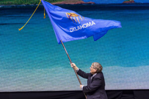 OKFB President Rodd Moesel presents the Oklahoma Flag at the 2023 AFBF Convention.