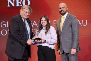 Oklahoma Farm Bureau President Rodd Moesel (left) and OKFB Young Farmers & Ranchers coordinator Zac Swartz (right) present Taylor Fent her award as the the 2022 OKFB Collegiate Discussion Meet winner on Saturday, Nov. 12 at the 2022 Oklahoma Farm Bureau Annual meeting in Norman, OK.