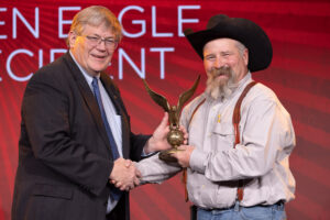 Oklahoma Farm Bureau President Rodd Moesel (left) presents Cleveland County Farm Bureau member Jake Calvert with the 2022 OKFB Golden Eagle Award on Saturday, Nov. 12 at the 2022 Oklahoma Farm Bureau Annual meeting in Norman, OK.