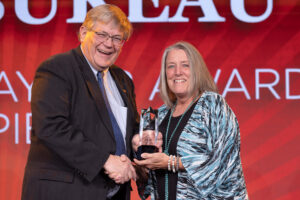 Oklahoma Farm Bureau President Rodd Moesel (left) presents Payne County Farm Bureau President Nancy German with the 2022 Oklahoma Farm Bureau John I. Taylor Award on Saturday, Nov. 12 at the 2022 Oklahoma Farm Bureau Annual meeting in Norman, OK.