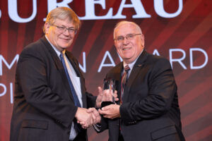 Oklahoma Farm Bureau President Rodd Moesel (left) presents Okmulgee County Farm Bureau President Jim Meek with the 2022 OKFB Lewis H. Moon award on Saturday, Nov. 12 at the 2022 Oklahoma Farm Bureau Annual meeting in Norman, OK.