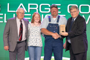 Oklahoma Farm Bureau President Rodd Moesel (right) presents Comanche County Farm Bureau members Kerry Givens (left), Cora Sullivan (second from left) and Joshua Sullivan with the OKFB County Excellence Award on Saturday, Nov. 11 at the 2023 Oklahoma Farm Bureau Annual meeting in Oklahoma City.