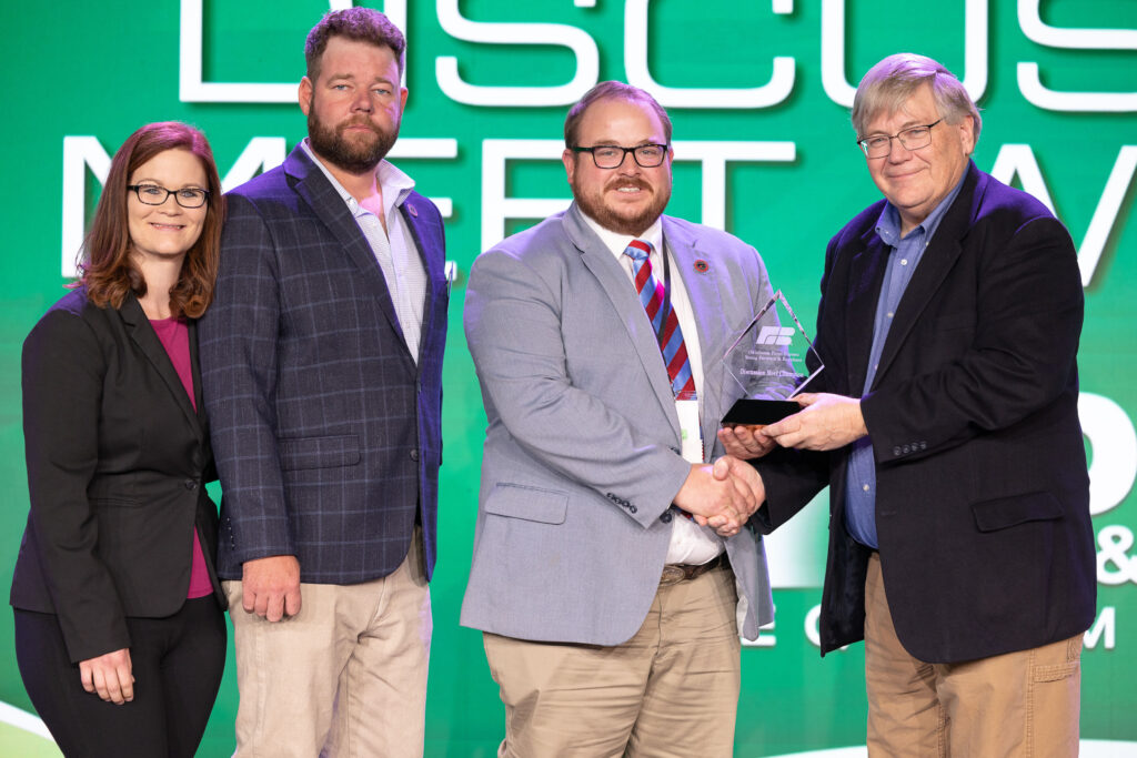 Oklahoma Farm Bureau Young Farmers & Ranchers chairs Alisen and Jared Anderson (left) and OKFB President Rodd Moesel (right) present Jacob Beck his award as the 2024 OKFB YF&R Discussion Meet winner on Saturday, Nov. 11 at the 2023 Oklahoma Farm Bureau Annual meeting in Oklahoma City.