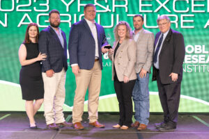 Jake and Meggie Gibbs (second and third from right) of Ottawa County receive the 2023 Oklahoma Farm Bureau Young Farmers & Ranchers Excellence in Agriculture Award on Saturday, Nov. 11 at the 2023 Oklahoma Farm Bureau Annual meeting in Oklahoma City.