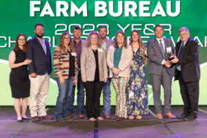 Oklahoma Farm Bureau President Rodd Moesel (right) presents Ottawa County Young Farmers & Ranchers members with the 2023 OKFB Charles L. Roff Award on Saturday, Nov. 11 at the 2023 Oklahoma Farm Bureau Annual meeting in Oklahoma City.